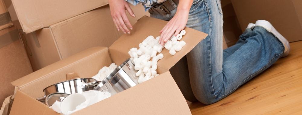 Moving house- Happy woman unpacking box.jpg